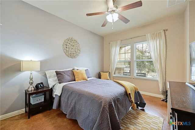 bedroom featuring a ceiling fan, visible vents, and baseboards