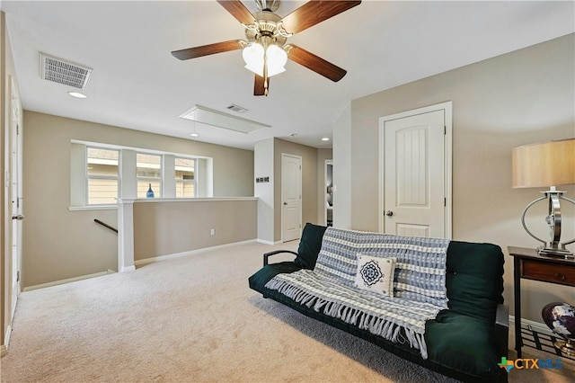 carpeted living area with attic access, visible vents, and baseboards