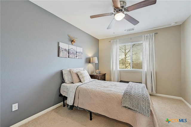 bedroom featuring light carpet, baseboards, visible vents, and ceiling fan