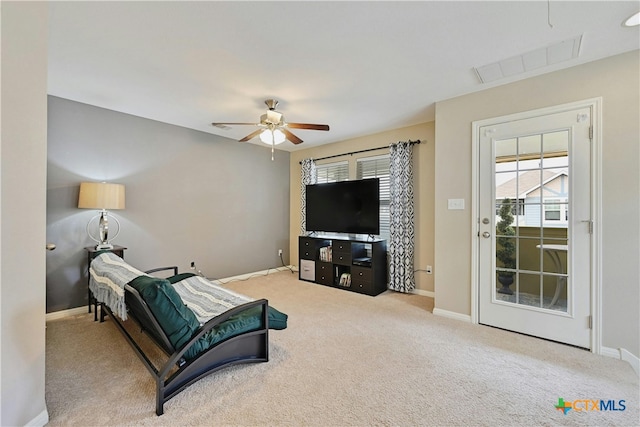 carpeted living room with visible vents, plenty of natural light, baseboards, and ceiling fan