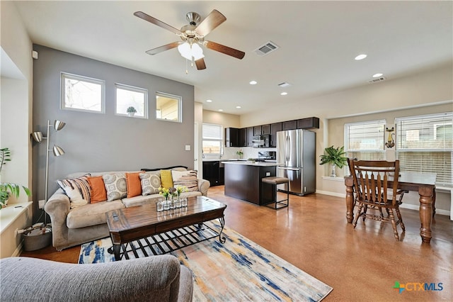 living room featuring baseboards, visible vents, ceiling fan, and recessed lighting