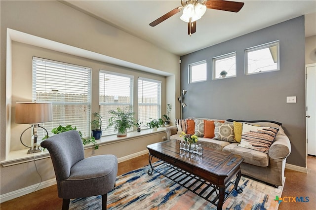 living room featuring ceiling fan and baseboards