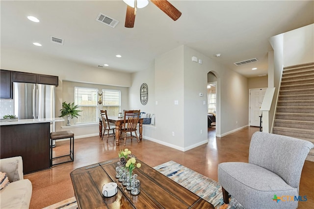 living room with recessed lighting, visible vents, and baseboards