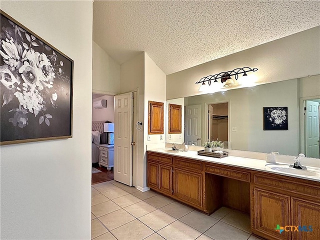 110 Ashford Dr, Victoria, TX 77904 - ensuite bathroom with lofted ceiling, double vanity, tile patterned floors, and a sink