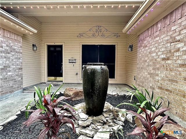 entrance to property with a patio area