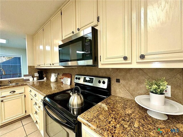 110 Ashford Dr, Victoria, TX 77904 - kitchen with a sink, stainless steel microwave, tasteful backsplash, and electric range oven