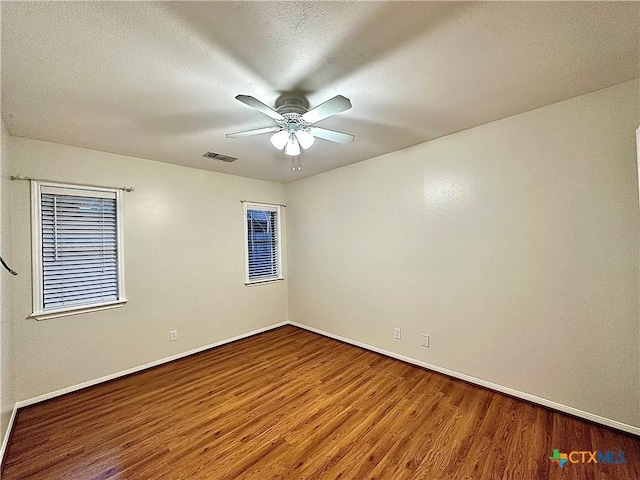 spare room with wood-type flooring, a textured ceiling, and ceiling fan