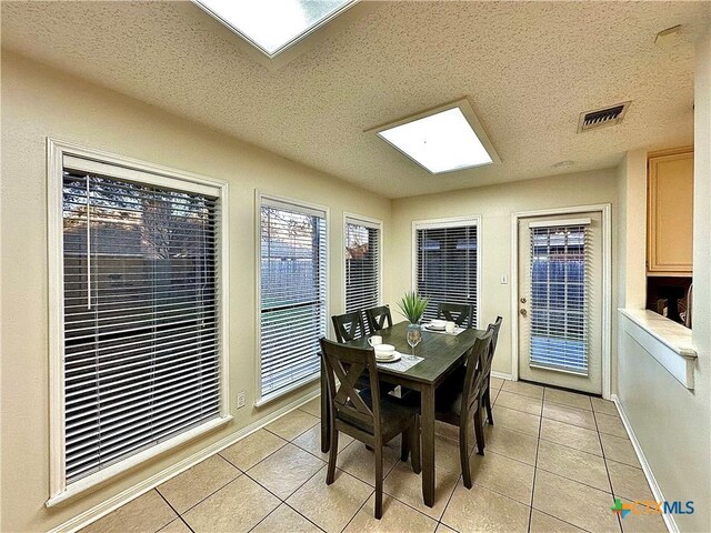 110 Ashford Dr, Victoria, TX 77904 - dining area featuring light tile patterned floors, baseboards, visible vents, and a textured ceiling
