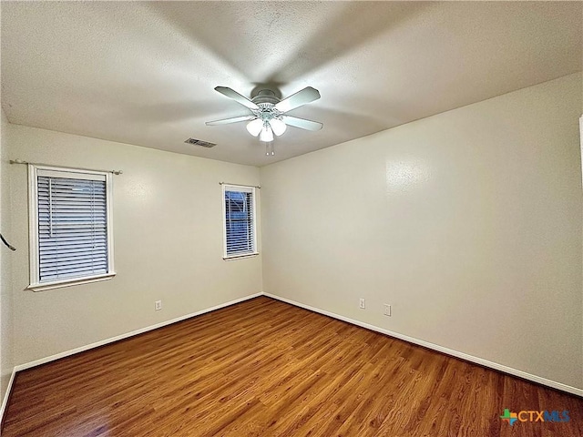 110 Ashford Dr, Victoria, TX 77904 - empty room with visible vents, baseboards, wood finished floors, a textured ceiling, and a ceiling fan