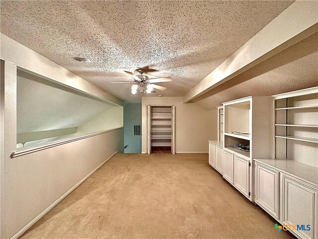 110 Ashford Dr, Victoria, TX 77904 - bonus room featuring baseboards, light colored carpet, vaulted ceiling, a textured ceiling, and a ceiling fan