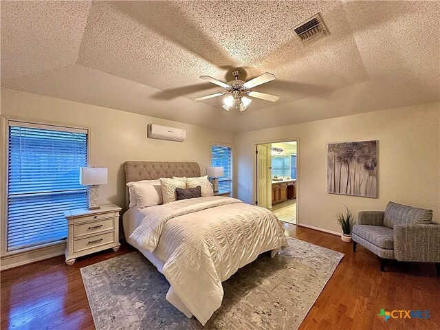 110 Ashford Dr, Victoria, TX 77904 - bedroom featuring visible vents, a textured ceiling, wood finished floors, and a wall mounted AC