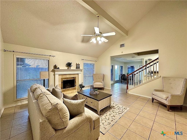 110 Ashford Dr, Victoria, TX 77904 - living room with visible vents, beam ceiling, light tile patterned floors, ceiling fan, and stairs
