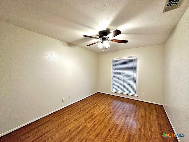 110 Ashford Dr, Victoria, TX 77904 - spare room featuring visible vents, baseboards, ceiling fan, wood finished floors, and a textured ceiling