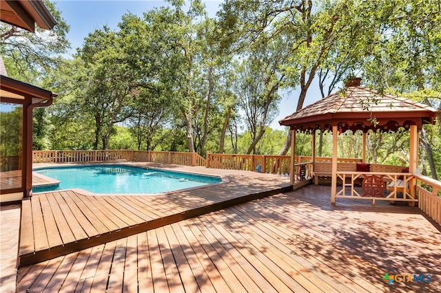 view of pool with a wooden deck and a gazebo