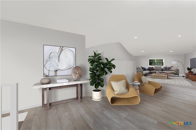 sitting room with light hardwood / wood-style floors and lofted ceiling