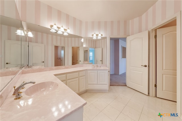 bathroom with vanity and a chandelier