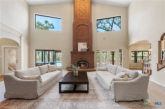 living room featuring high vaulted ceiling and a healthy amount of sunlight