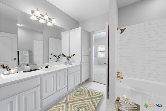 bathroom with vanity, tile patterned floors, and tiled shower / bath