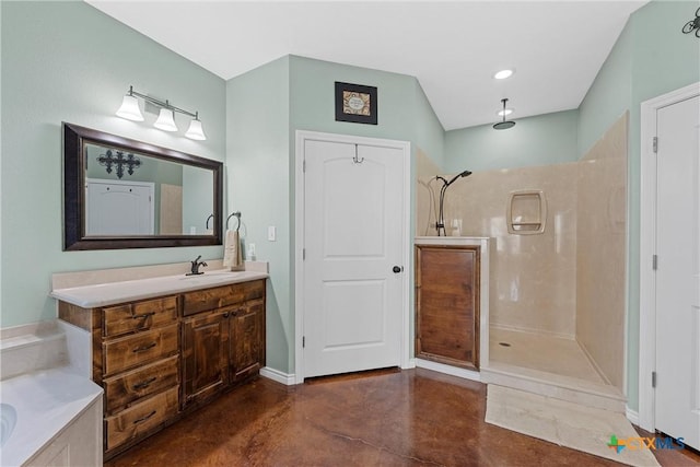 bathroom featuring vanity, a walk in shower, concrete flooring, baseboards, and a bathtub