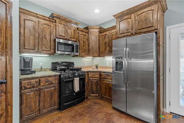 kitchen with recessed lighting, appliances with stainless steel finishes, light stone counters, and finished concrete flooring