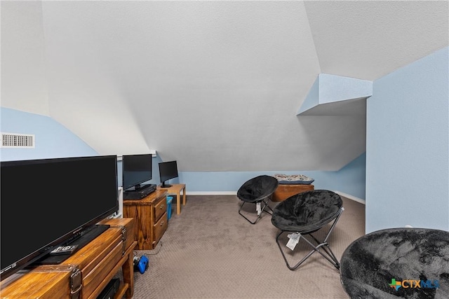 interior space with lofted ceiling, carpet floors, visible vents, and baseboards