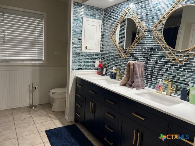 bathroom with vanity, toilet, and tile patterned flooring