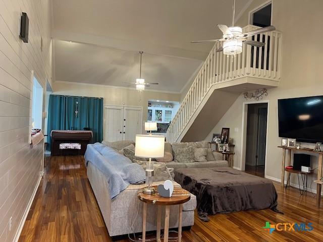 bedroom featuring ceiling fan, high vaulted ceiling, and hardwood / wood-style floors