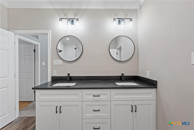 bathroom with vanity, wood-type flooring, and crown molding