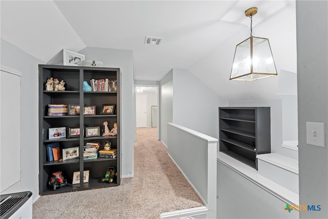 hall with carpet and lofted ceiling