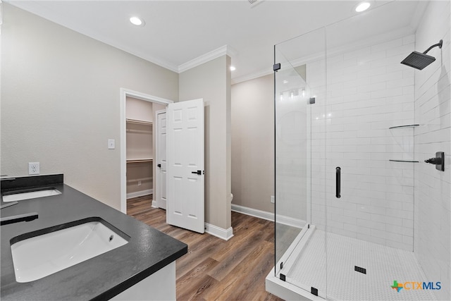 bathroom featuring ornamental molding, wood-type flooring, toilet, and a shower with door