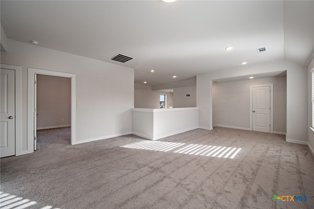 empty room with visible vents, recessed lighting, baseboards, and carpet