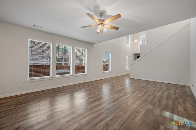 unfurnished living room with visible vents, baseboards, wood finished floors, and a ceiling fan