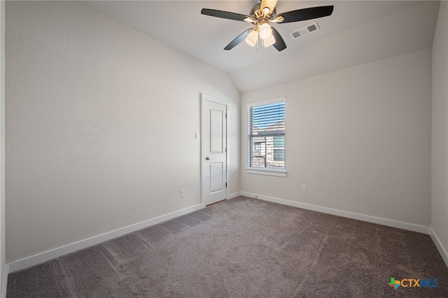 unfurnished room with visible vents, baseboards, ceiling fan, lofted ceiling, and carpet flooring