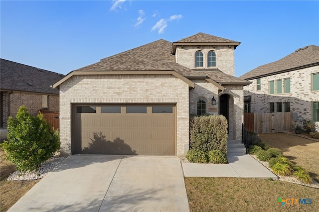 view of front of property with brick siding, an attached garage, a shingled roof, fence, and driveway