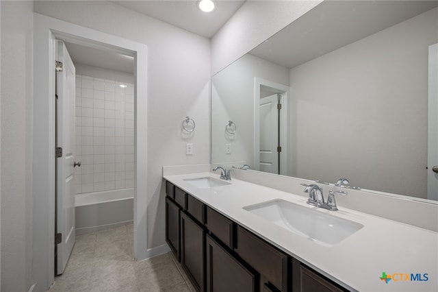 full bathroom featuring double vanity, tile patterned flooring, and a sink