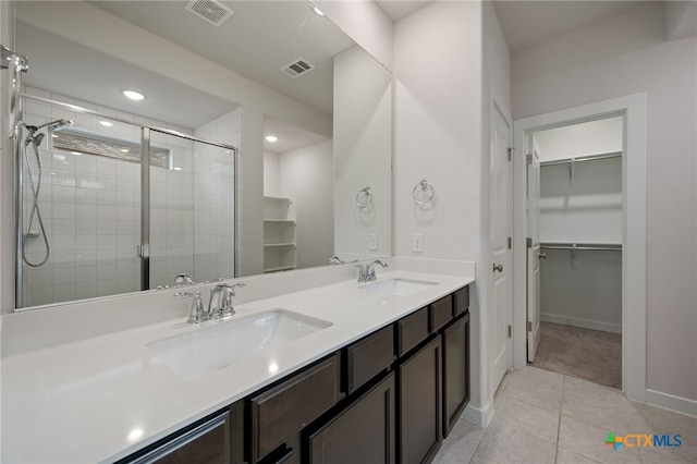 full bathroom with visible vents, a stall shower, and a sink