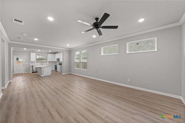 704 Seven Springs Dr, Temple, TX 76502 - unfurnished living room with crown molding, visible vents, baseboards, and light wood-style floors