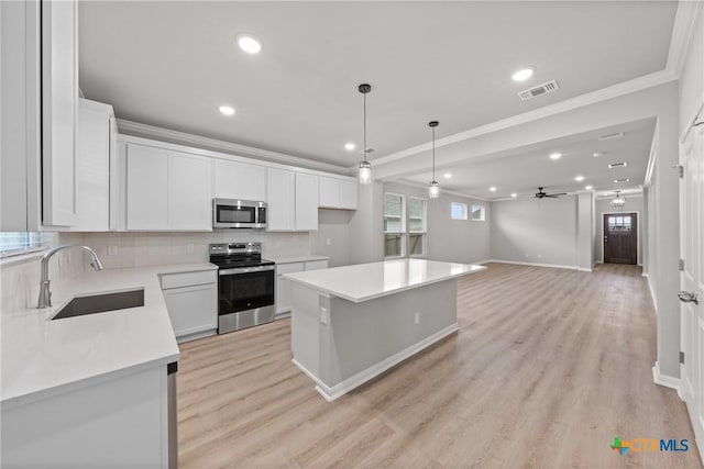 704 Seven Springs Dr, Temple, TX 76502 - kitchen featuring ornamental molding, white cabinets, visible vents, appliances with stainless steel finishes, and a sink