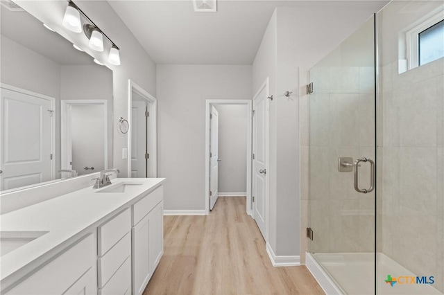 704 Seven Springs Dr, Temple, TX 76502 - full bathroom with a stall shower, wood finished floors, a sink, and baseboards