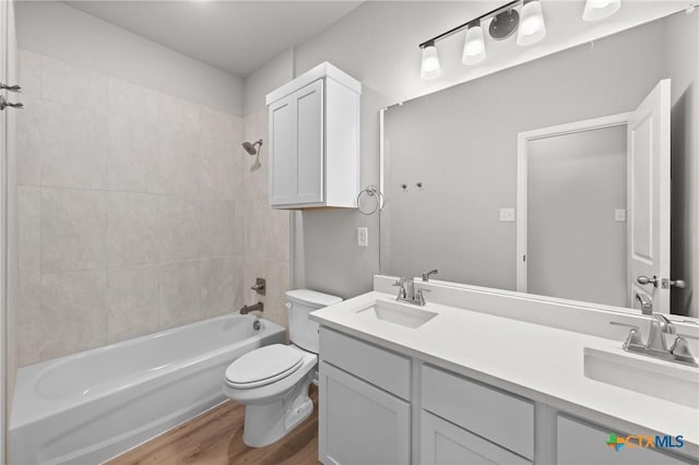 704 Seven Springs Dr, Temple, TX 76502 - bathroom with toilet, wood finished floors, a sink, and  shower combination