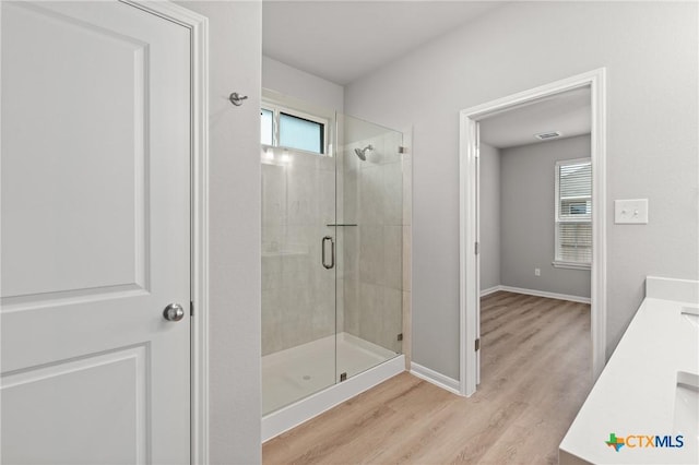 704 Seven Springs Dr, Temple, TX 76502 - bathroom with a shower stall, vanity, baseboards, and wood finished floors