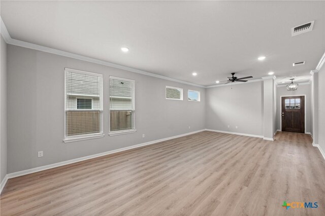 704 Seven Springs Dr, Temple, TX 76502 - unfurnished living room with visible vents, baseboards, crown molding, and light wood-style flooring