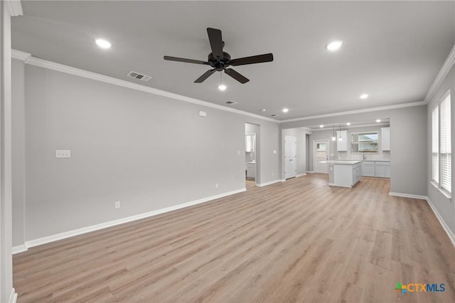 704 Seven Springs Dr, Temple, TX 76502 - unfurnished living room featuring visible vents, baseboards, ornamental molding, light wood-type flooring, and a ceiling fan