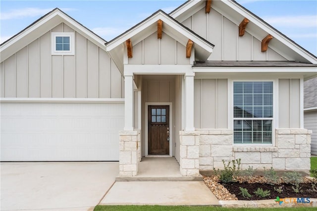 704 Seven Springs Dr, Temple, TX 76502 - view of front of house featuring board and batten siding, concrete driveway, a garage, and stone siding