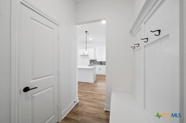 hallway with light wood-type flooring