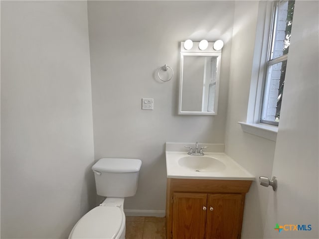 bathroom featuring vanity, tile patterned floors, and toilet