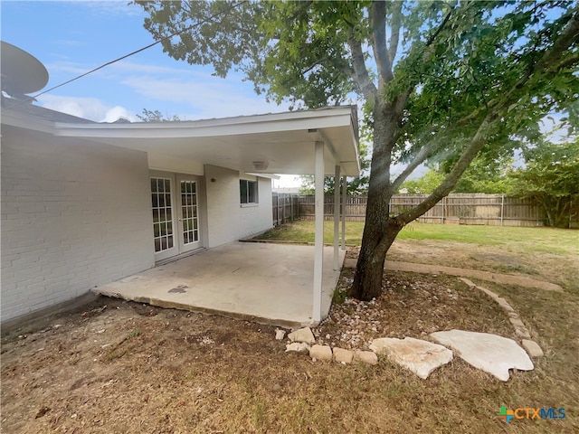 view of yard featuring french doors and a patio area