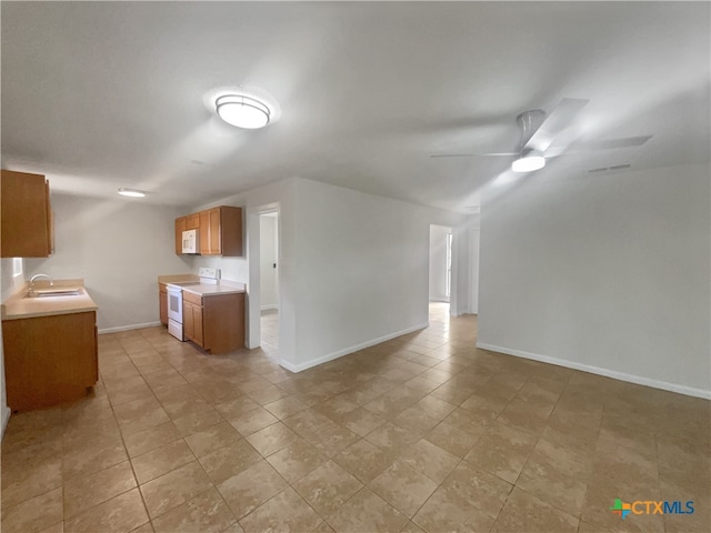 interior space with sink, white appliances, and ceiling fan