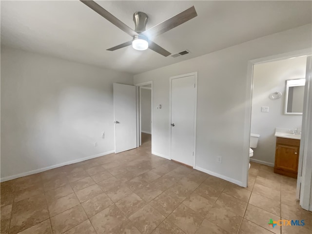 unfurnished bedroom with ensuite bath, ceiling fan, and sink