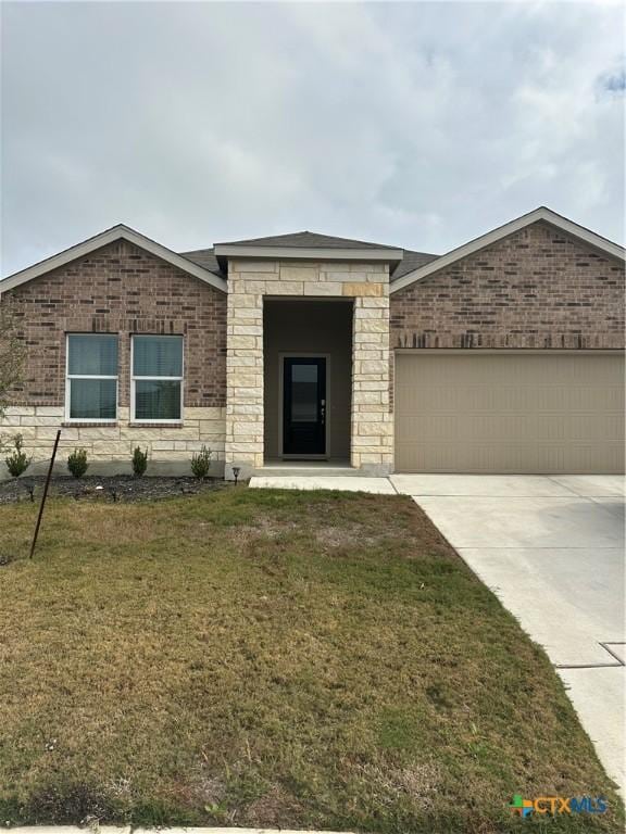 view of front of property with a garage and a front lawn